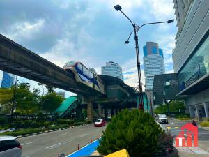 a train on a bridge over a city street at Heaven Cottage KLCC Suite in Kuala Lumpur