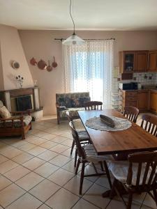 a living room with a wooden table and chairs at Casa Capoleto in Torre le Nocelle