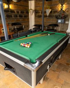 a pool table with balls on top of it at Redhill Container House & Private Spa in Nairobi
