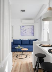 uma sala de estar com um sofá azul e uma mesa em Alyvia Central Apartment 2 em Ioannina