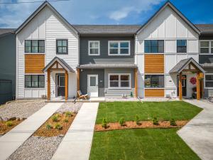 a large house with a lawn in front of it at Serene Peaks, Private Hot Tub, Peaceful in Radium Hot Springs