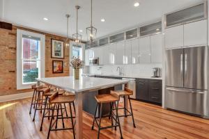 a kitchen with a large kitchen island with bar stools at Broughton Haven in Savannah