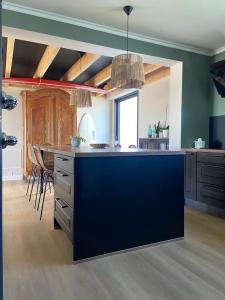 a kitchen with a blue island in a room at Jolie villa face aux dunes et mer in Brétignolles-sur-Mer +12 photos