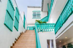 a staircase in a building with green railings at Hotel Casa Turquesa in Flores