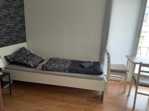 a bed with two pillows on it in a room at Schönes einfaches Zimmer zentral in Wilhelmshaven in Wilhelmshaven