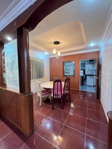a kitchen and dining room with a table and chairs at Bintulu AirBnB Homestay in Bintulu
