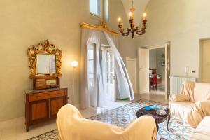 a living room with a couch and a mirror at Palazzo Zacà in Gallipoli