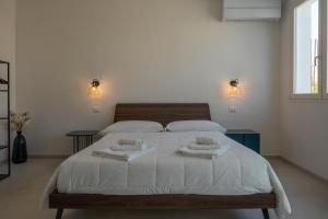 Postel nebo postele na pokoji v ubytování Murieri Rooms