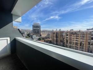 a balcony with a view of the city at New Prishtina Luxury Rooms in Pristina