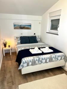 a bedroom with a bed with two dishes on it at Apartman Dino in Fažana