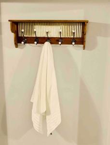 a towel hanging on a towel rack on a wall at Casita Blanca- Close To Downtown in Waco