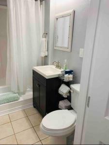 a bathroom with a toilet and a sink and a shower at Casita Blanca- Close To Downtown in Waco