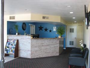 a lobby with a counter with stars on the wall at Relax Inn Marlin in Marlin