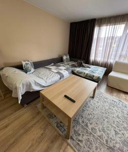 a bedroom with a bed and a coffee table at Johannesburg Spacious Family apt w Free Parking and Playground in Sofia