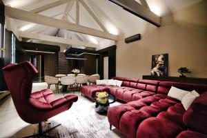a living room with a red couch and a table at Lake Park in Zator +76 photos