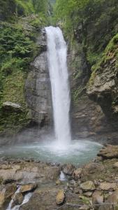 een waterval aan de kant van een berg met water bij Guest house lagodekhi in Lagodekhi