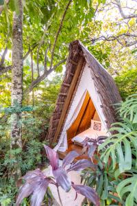 a doghouse in the middle of a forest at Hostel Da Vila Ilhabela in Ilhabela