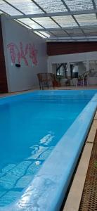 a large swimming pool with blue water in a building at Nina Hostel in San Carlos de Bariloche
