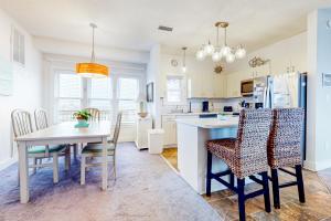 a kitchen and dining room with a table and chairs at About the Waves in Avon
