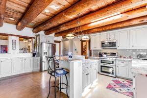 a kitchen with white cabinets and a wooden ceiling at The Desert Z Lounge in Tucson