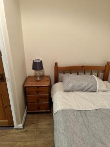 a bedroom with two beds and a lamp on a nightstand at The Gallery in Middlesbrough