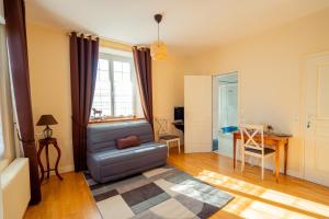 een woonkamer met een bank en een tafel bij RELAIS SAINT JACQUES in Amboise