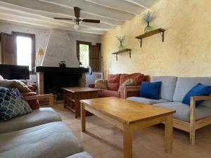 a living room with couches and a coffee table at Casas Amarillas. Finca el Campillo in Blanca