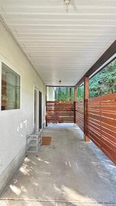 an empty porch of a house with a fence at Creek Side 2-Bedroom Guest Suite in Burnaby