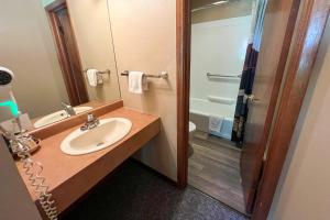 a bathroom with a sink and a shower at Castle Mountain Lodge in Estes Park