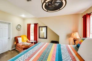 a bedroom with a bed and a chair and a window at Lake Granbury Fishing Escape with Dock and Kayaks! in Granbury