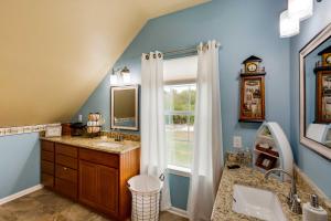a bathroom with a tub and a sink and a mirror at Lake Granbury Fishing Escape with Dock and Kayaks! in Granbury +34 photos