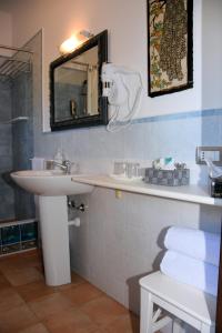 a bathroom with a sink and a mirror at Guest House La Carolina in Tigliole