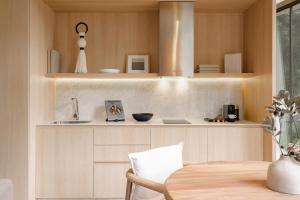 a kitchen with wooden cabinets and a wooden table at ONTO Tonalá Mexico City in Mexico City