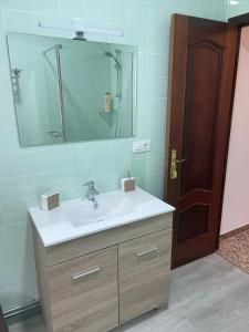 a bathroom with a sink and a mirror at Balcón da Ría 
