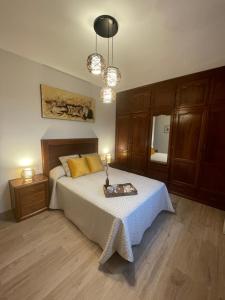 a bedroom with a bed with a tray on it at Balcón da Ría 