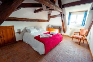 ein Schlafzimmer mit einem großen Bett mit einer roten Decke in der Unterkunft RELAIS SAINT JACQUES in Amboise
