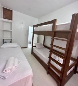 a bedroom with two bunk beds and a ladder at Pousada VIGLAMO JERI in Jericoacoara