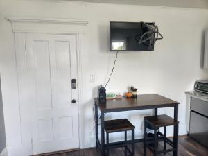 a room with a table and a television on the wall at Street side studio apartment in Manchester