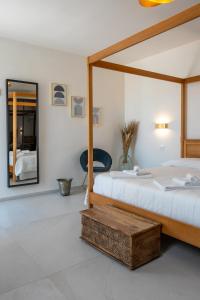 a bedroom with two beds and a mirror at Murieri Rooms in Otranto