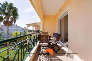 a balcony with two chairs and a view of the ocean at #130 Praia Village by Home Holidays in Vilamoura