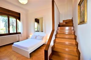 a bedroom with a bed and a stair case at Stazione, Chieri - Casa Vittoria in Chieri