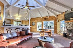 een woonkamer met een bank en een tafel bij Lazy Bear Lookout - hexagon cabin with resort views in Big Bear Lake