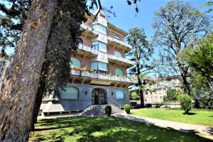 a large building with a balcony on top of it at Stazione, Chieri - Casa Vittoria in Chieri