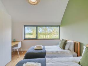 Un pat sau paturi într-o cameră la Babbelkous, Bramfield