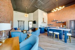 a living room with blue furniture and a brick wall at Idyllic Biggsville Vacation Rental 10 Mi to River 