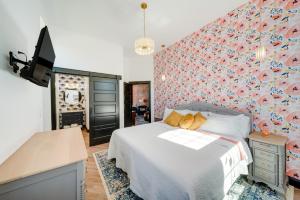 a bedroom with a bed and a wall covered in flowers at Idyllic Biggsville Vacation Rental 10 Mi to River in Biggsville