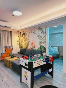 a living room with a foosball table in the middle of a room at Holiday Escape Philippines in Manila