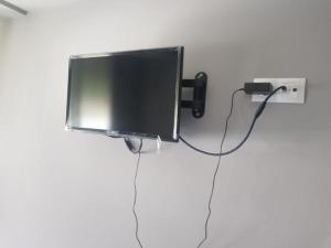 a flat screen tv hanging on a wall at Habitaciones en Ronda in Castro-Urdiales +3 photos