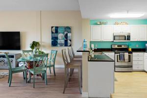 a kitchen and dining room with a table and chairs at Madeira Bay Resort 509 in St Pete Beach