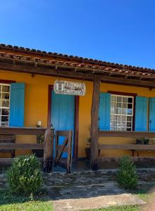 an orange and blue building with a sign on it at Fazenda do Engenho in Ritápolis